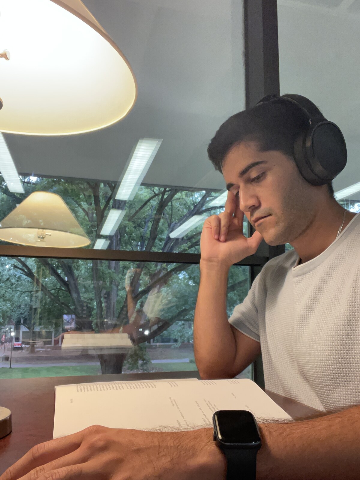 Alejandro reading at a desk